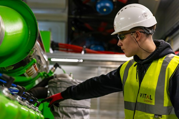 Safety worker inspecting industrial equipment